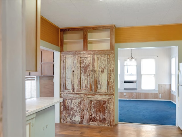 1233 Eagle Lake Rd, Sealy, TX 77474 - kitchen with cooling unit, wood finished floors, light countertops, and wooden walls
