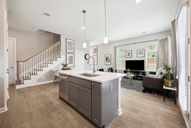 6024 T C Jester Blvd, Houston, TX 77091 - kitchen with gray cabinetry, stainless steel dishwasher, light wood finished floors, light countertops, and recessed lighting