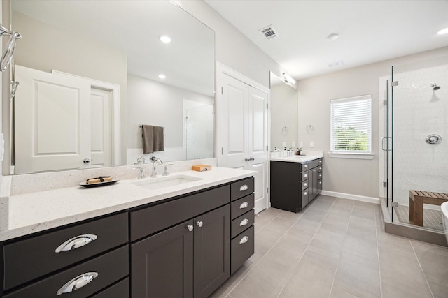 6024 T C Jester Blvd, Houston, TX 77091 - full bath with a stall shower, two vanities, tile patterned flooring, and recessed lighting