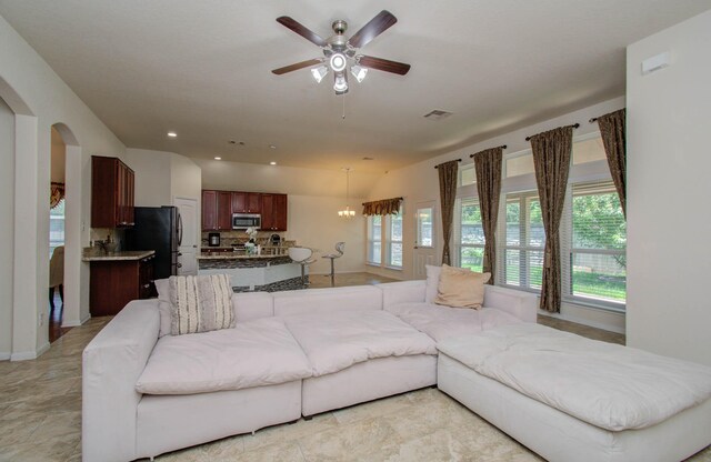 15218 Zenith Glen Ln, Cypress, TX 77429 - living room with arched walkways, ceiling fan, recessed lighting, and a chandelier