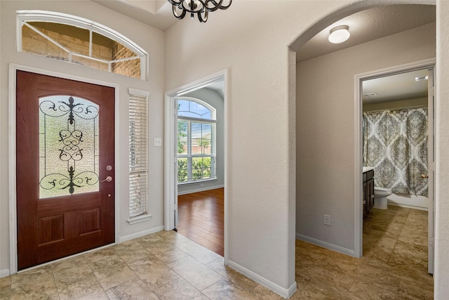 15218 Zenith Glen Ln, Cypress, TX 77429 - entryway with arched walkways and a chandelier