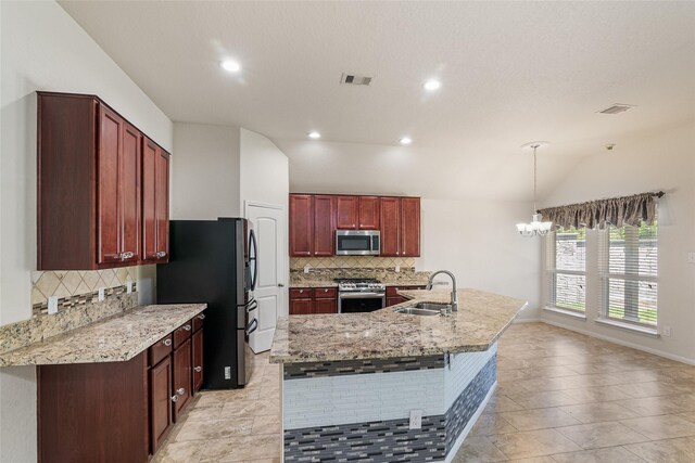 15218 Zenith Glen Ln, Cypress, TX 77429 - kitchen with appliances with stainless steel finishes, tasteful backsplash, a chandelier, a center island with sink, and recessed lighting