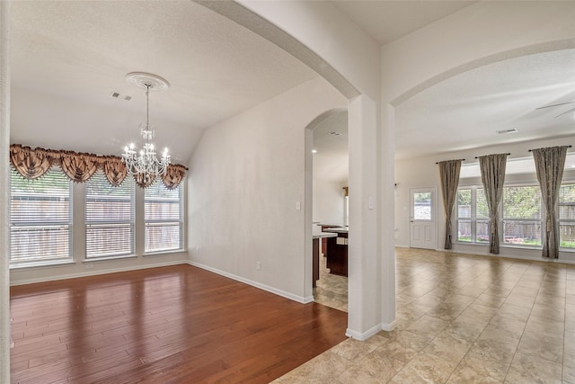 15218 Zenith Glen Ln, Cypress, TX 77429 - unfurnished room with arched walkways, wood finished floors, a ceiling fan, a chandelier, and vaulted ceiling