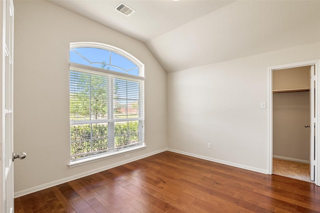 15218 Zenith Glen Ln, Cypress, TX 77429 - unfurnished bedroom with vaulted ceiling, hardwood / wood-style floors, and a walk in closet