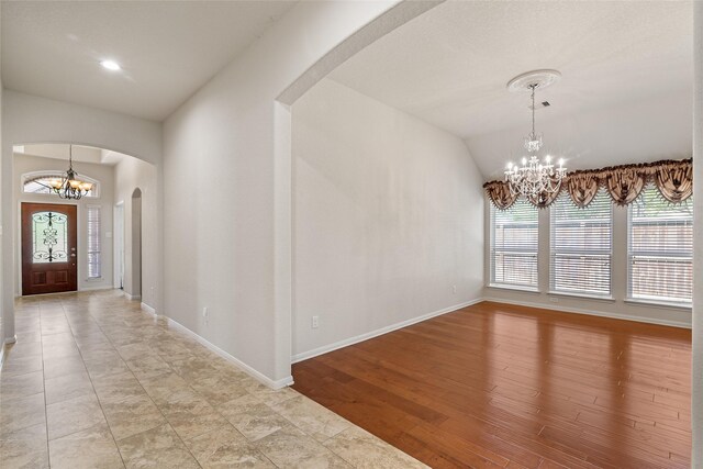 15218 Zenith Glen Ln, Cypress, TX 77429 - entrance foyer with a chandelier, arched walkways, and lofted ceiling