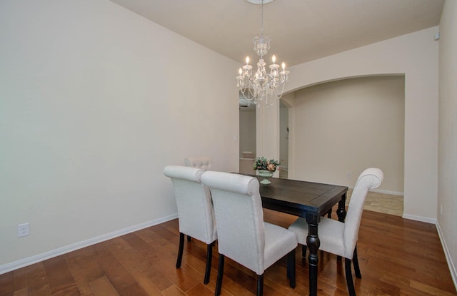 15218 Zenith Glen Ln, Cypress, TX 77429 - dining room with arched walkways, wood finished floors, and a chandelier