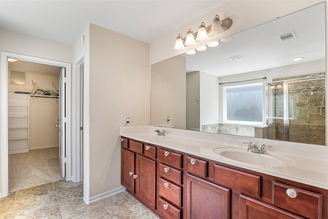 15218 Zenith Glen Ln, Cypress, TX 77429 - full bathroom featuring double vanity, a spacious closet, and a stall shower