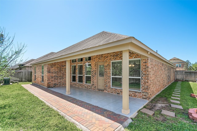 15218 Zenith Glen Ln, Cypress, TX 77429 - back of property with brick siding, a fenced backyard, a patio, and a shingled roof