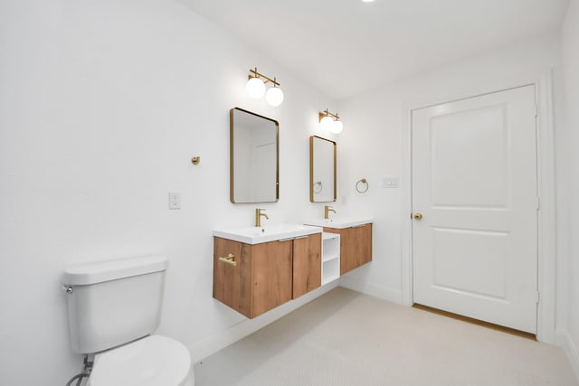 300 Narcissus Rd, Clear Lake Shores, TX 77565 - bathroom featuring double vanity and toilet