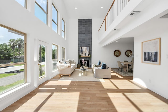 300 Narcissus Rd, Clear Lake Shores, TX 77565 - living area with a towering ceiling, wood finished floors, and a fireplace