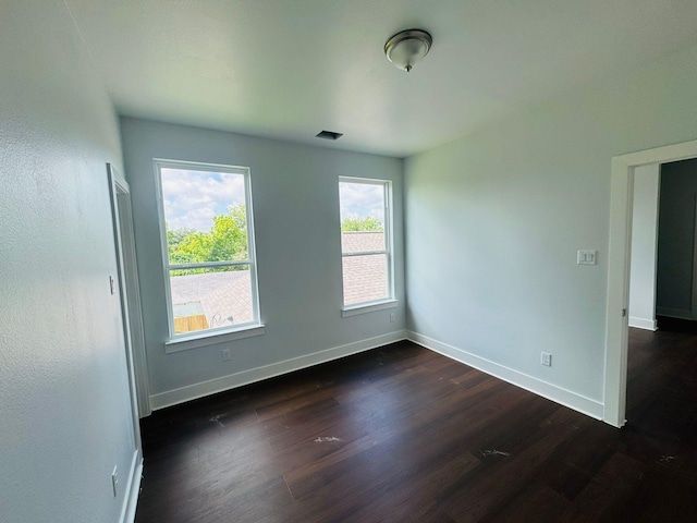 8128 Penrod St, Houston, TX 77028 - empty room with dark wood-style floors and baseboards