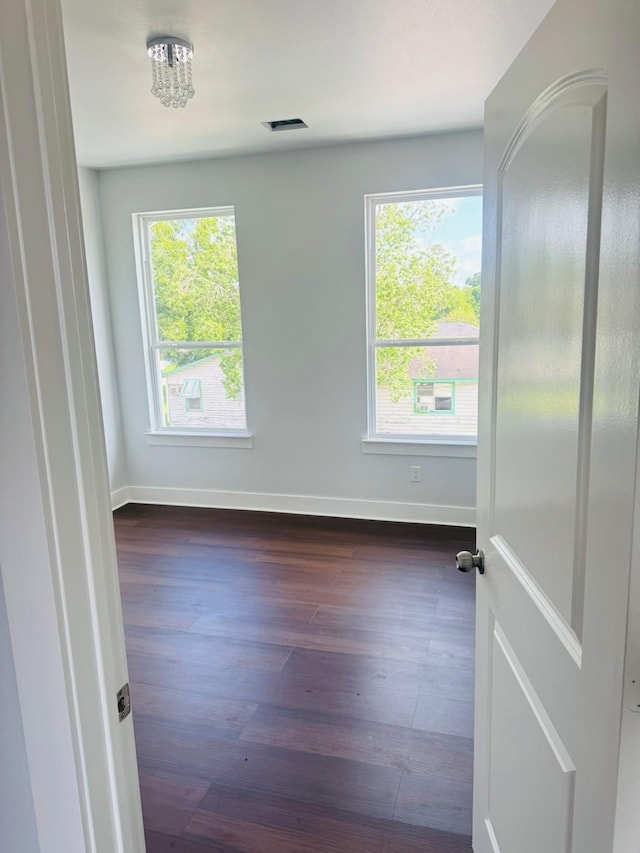 8128 Penrod St, Houston, TX 77028 - spare room featuring plenty of natural light and dark wood-type flooring