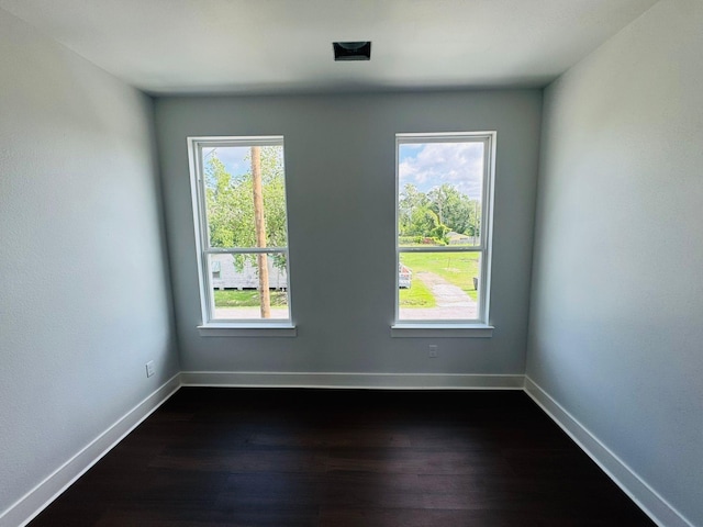 8128 Penrod St, Houston, TX 77028 - spare room featuring healthy amount of natural light and dark wood-style floors