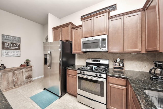 18614 Magnolia Dell Dr, Cypress, TX 77433 - kitchen with stainless steel appliances, decorative backsplash, and dark stone countertops