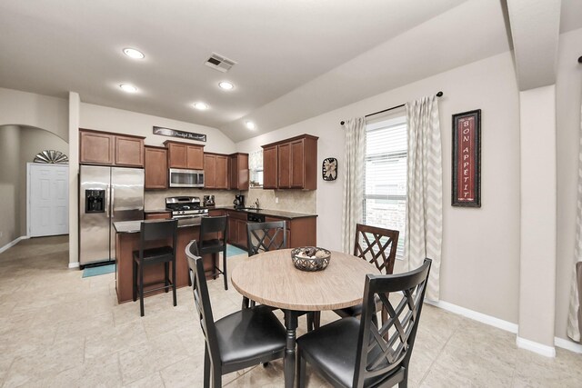 18614 Magnolia Dell Dr, Cypress, TX 77433 - dining room with lofted ceiling, arched walkways, and recessed lighting