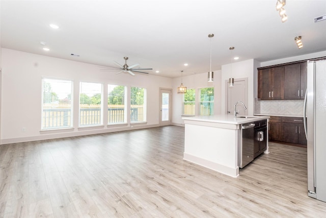 10513 Chesterfield Dr, Houston, TX 77051 - kitchen with stainless steel dishwasher, dark brown cabinets, light countertops, recessed lighting, and light wood-style floors