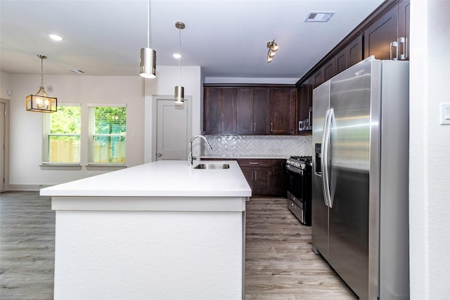 10513 Chesterfield Dr, Houston, TX 77051 - kitchen featuring appliances with stainless steel finishes, light wood-style floors, dark brown cabinetry, backsplash, and light countertops