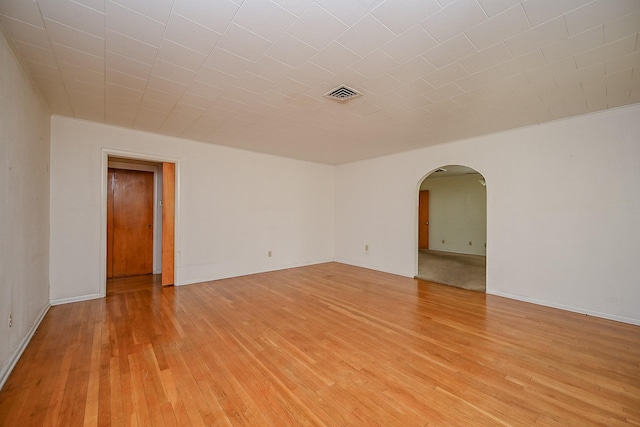 702 Mcdaniel St, Houston, TX 77022 - unfurnished room with arched walkways and light wood finished floors