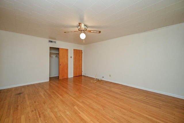 702 Mcdaniel St, Houston, TX 77022 - unfurnished bedroom with light wood finished floors, two closets, and ceiling fan