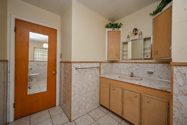 702 Mcdaniel St, Houston, TX 77022 - bathroom with ornamental molding, tile patterned flooring, vanity, tile walls, and a wainscoted wall