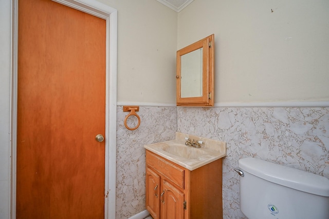 702 Mcdaniel St, Houston, TX 77022 - half bath featuring vanity, crown molding, and a wainscoted wall