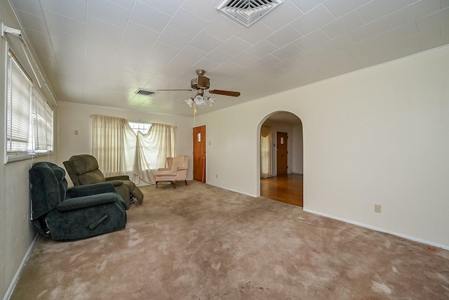 702 Mcdaniel St, Houston, TX 77022 - carpeted living room featuring arched walkways and a ceiling fan