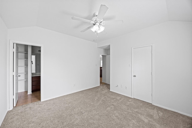 2850 Back Bay Brook Trl, Houston, TX 77045 - unfurnished bedroom featuring vaulted ceiling, carpet flooring, ensuite bath, and ceiling fan
