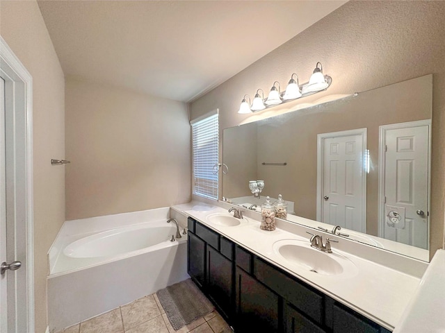 17410 Sandalisle Ln, Richmond, TX 77407 - bathroom with double vanity, a bath, and tile patterned flooring