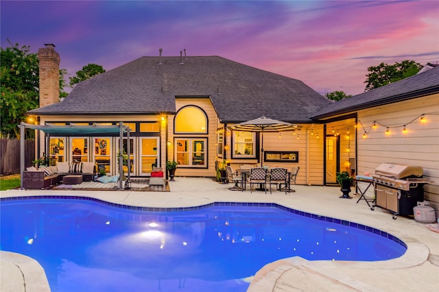 5631 Spring Lodge Dr, Houston, TX 77345 - pool at dusk featuring an outdoor hangout area, a grill, an outdoor pool, and a patio area