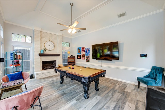 5631 Spring Lodge Dr, Houston, TX 77345 - recreation room featuring wood finished floors, billiards table, a brick fireplace, a ceiling fan, and ornamental molding