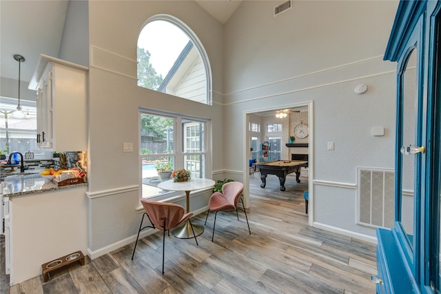 5631 Spring Lodge Dr, Houston, TX 77345 - dining space with billiards table, high vaulted ceiling, light wood finished floors, and ceiling fan