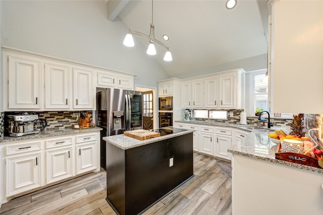 5631 Spring Lodge Dr, Houston, TX 77345 - kitchen with black appliances, decorative backsplash, white cabinetry, high vaulted ceiling, and light stone counters