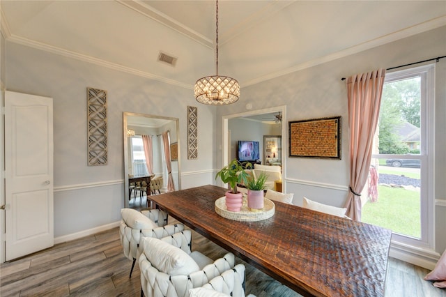 5631 Spring Lodge Dr, Houston, TX 77345 - dining room featuring healthy amount of natural light, wood finished floors, and crown molding