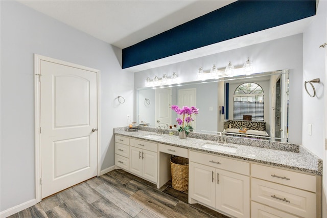 5631 Spring Lodge Dr, Houston, TX 77345 - bathroom featuring wood finished floors and double vanity