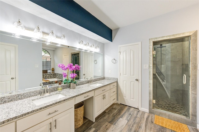 5631 Spring Lodge Dr, Houston, TX 77345 - full bathroom with double vanity, wood finished floors, and a shower stall