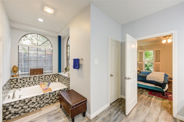 5631 Spring Lodge Dr, Houston, TX 77345 - full bath featuring wood finished floors, a garden tub, and ceiling fan