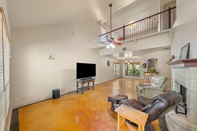 172 Candy Rd, Pipe Creek, TX 78063 - living area featuring ceiling fan, concrete floors, a fireplace, high vaulted ceiling, and arched walkways