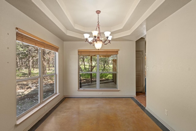 172 Candy Rd, Pipe Creek, TX 78063 - unfurnished dining area with a chandelier, concrete flooring, and a raised ceiling