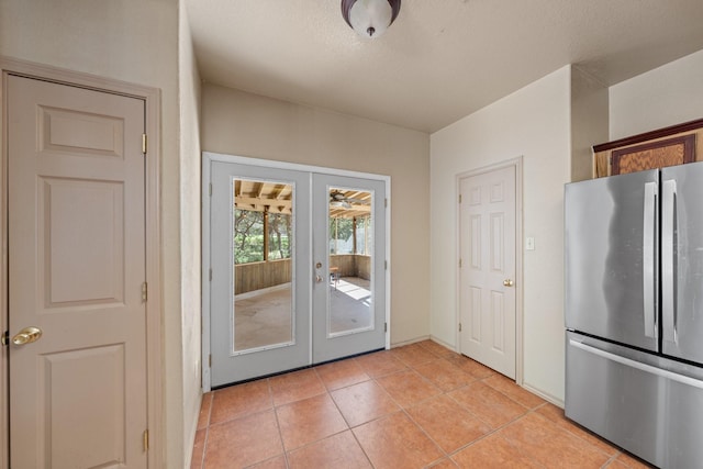 172 Candy Rd, Pipe Creek, TX 78063 - kitchen featuring freestanding refrigerator, french doors, and light tile patterned floors