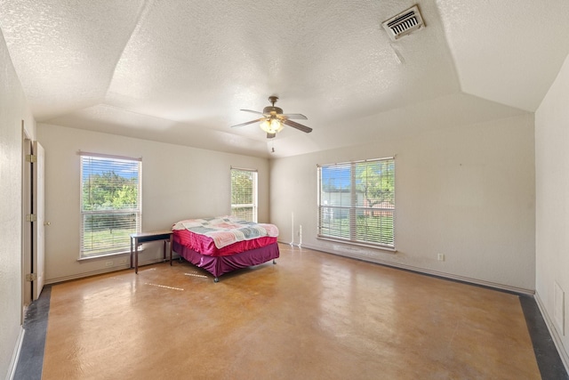 172 Candy Rd, Pipe Creek, TX 78063 - bedroom with finished concrete floors, ceiling fan, and a textured ceiling
