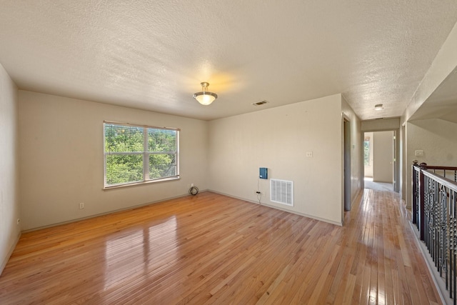 172 Candy Rd, Pipe Creek, TX 78063 - empty room with a textured ceiling and light wood-type flooring