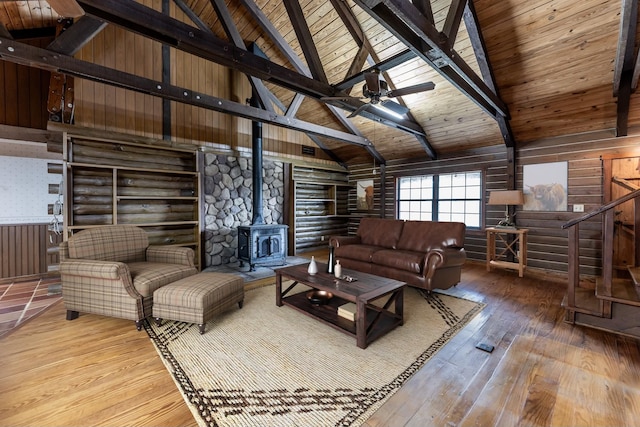 800 Fm 980 S, Point Blank, TX 77364 - living area with a wood stove, stairs, hardwood / wood-style floors, ceiling fan, and a wooden ceiling with exposed beams