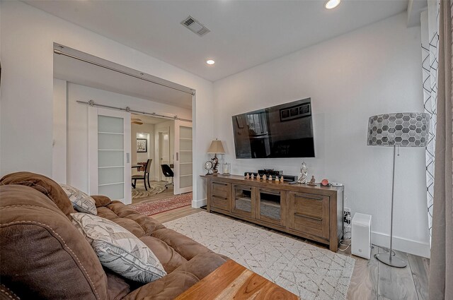 6628 Bayou Glen Rd Unit 6628, Houston, TX 77057 - living room with light wood-style floors, recessed lighting, and a barn door