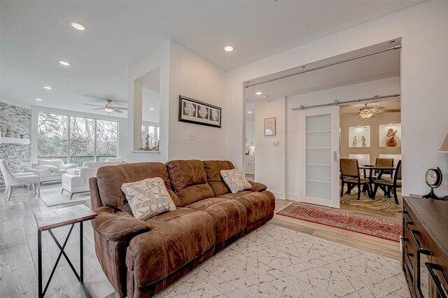 6628 Bayou Glen Rd Unit 6628, Houston, TX 77057 - living area featuring light wood finished floors, ceiling fan, recessed lighting, and a barn door