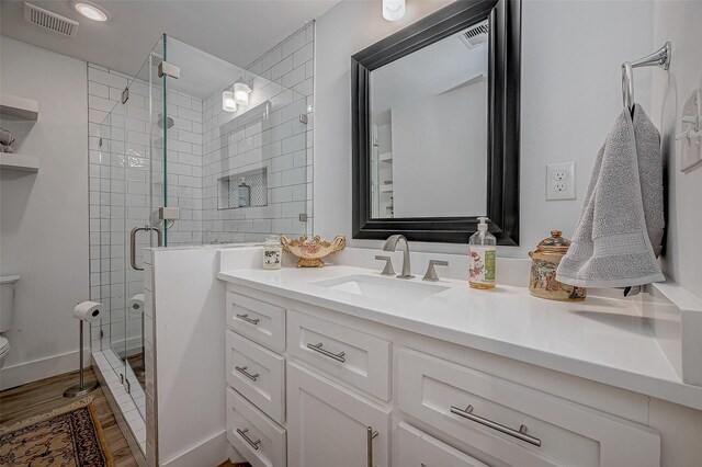 6628 Bayou Glen Rd Unit 6628, Houston, TX 77057 - bathroom featuring vanity, wood finished floors, a shower stall, and recessed lighting
