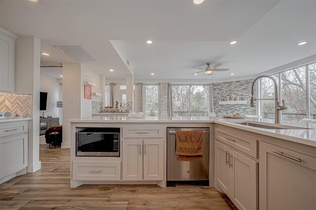 6628 Bayou Glen Rd Unit 6628, Houston, TX 77057 - kitchen with built in microwave, dishwasher, decorative backsplash, a ceiling fan, and light countertops