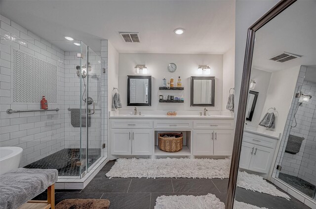 6628 Bayou Glen Rd Unit 6628, Houston, TX 77057 - bathroom with a stall shower, double vanity, a freestanding tub, recessed lighting, and tile patterned flooring
