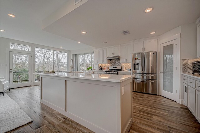 6628 Bayou Glen Rd Unit 6628, Houston, TX 77057 - kitchen featuring stainless steel appliances, under cabinet range hood, light countertops, decorative backsplash, and recessed lighting