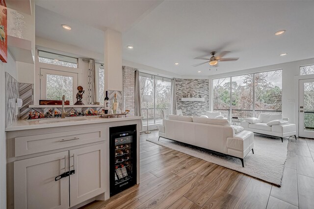 6628 Bayou Glen Rd Unit 6628, Houston, TX 77057 - living room featuring wine cooler, ceiling fan, healthy amount of natural light, light wood finished floors, and recessed lighting