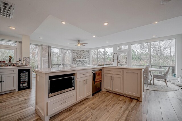 6628 Bayou Glen Rd Unit 6628, Houston, TX 77057 - kitchen with stainless steel appliances, beverage cooler, light wood-style flooring, light countertops, and recessed lighting